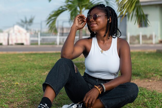 Full shot young woman sitting on grass