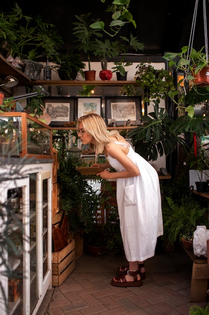 Full shot young woman surrounded by plants