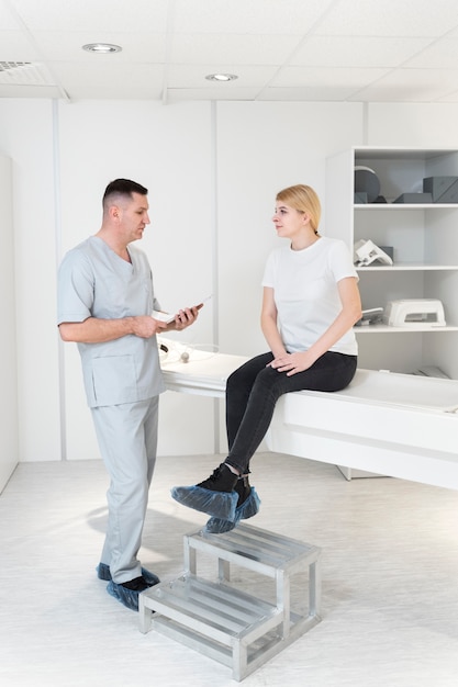 full shot young woman talking to nurse