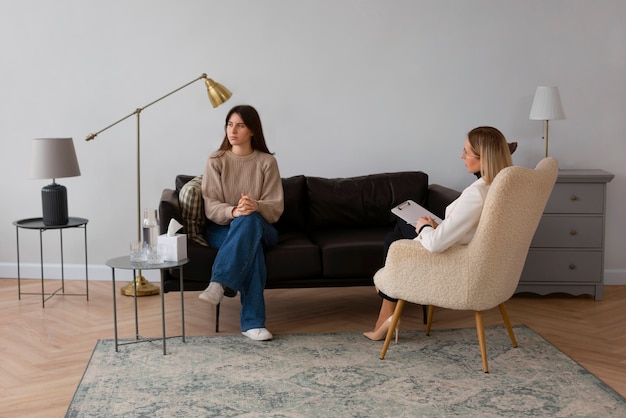 Full shot young woman undergoing therapy