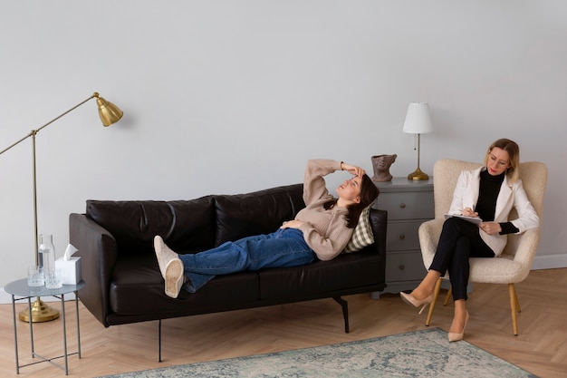 Full shot young woman undergoing therapy