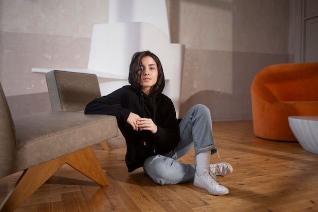 Full shot young woman wearing black hoodie