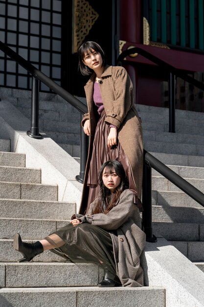 Full shot young women on stairs