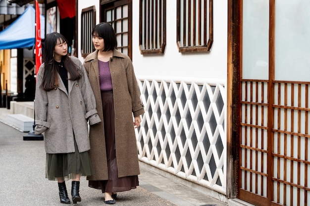 Full shot young women walking together