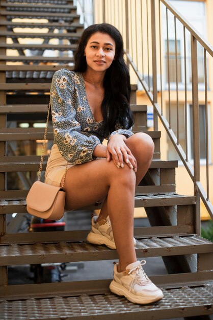 Full size body of woman sitting on stairs