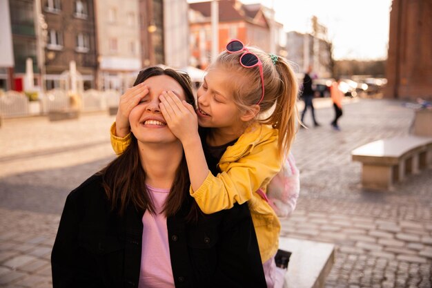 Full view of cute family mom and kid on street