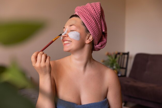 Full view of happy woman with mask on face at home