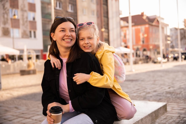 Full view of mom and kid on street