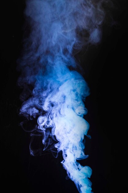 Fumes of purple smoke at the center of the black backdrop