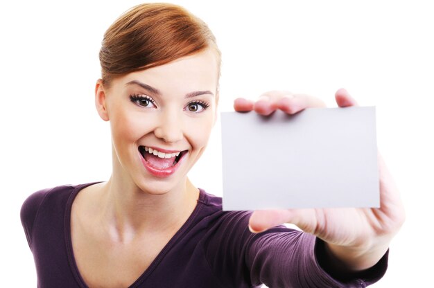 Fun and laughing beautiful female person with blank business card  in hand. High angle view