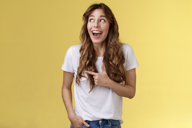 Funny amused cute girlfriend enjoy awesome party having wonderful time spend amazing day city fair open mouth surprised fascinated observe admiration lgbtq pride parade happy yellow background