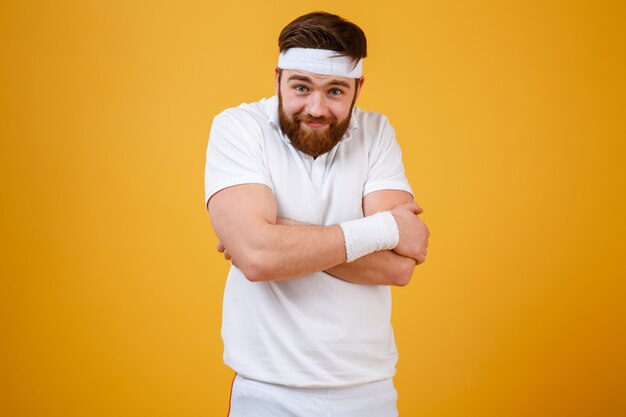 Funny bearded sportsman with crossed arms