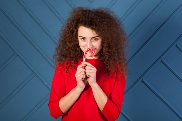 Funny brunette girl portrait on blue background