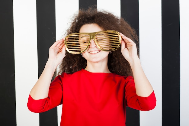 Funny brunette girl portrait on striped background