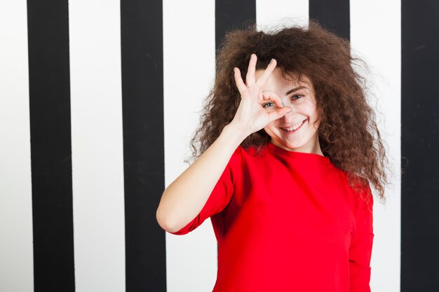 Funny brunette girl portrait on striped background