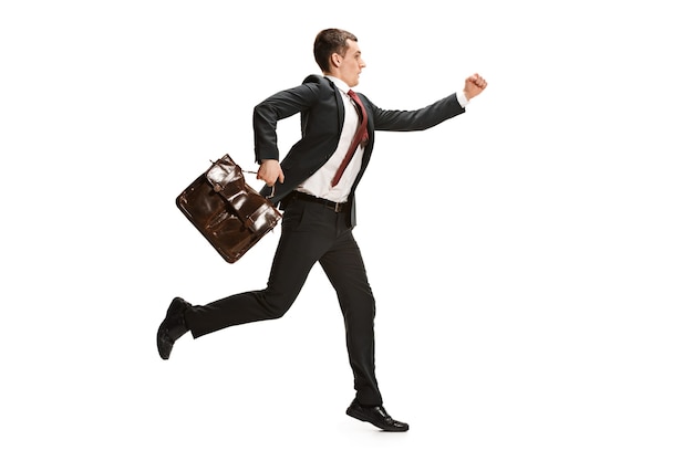 Funny cheerful businessman running over white studio background. happy young man in suit. Business, career, success, win concept. Victory, delight . Human facial emotions