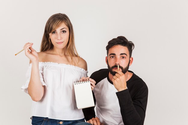 Funny couple holding notepad