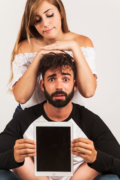 Free photo funny couple holding tablet