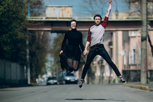 Funny couple jumping on the street