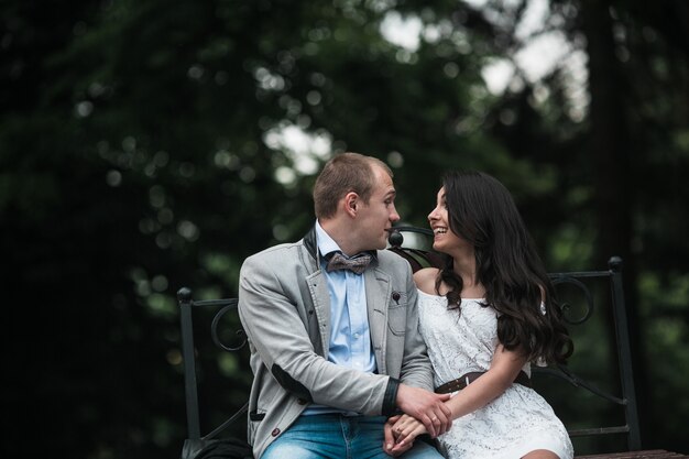 Funny couple looking at each other in the park