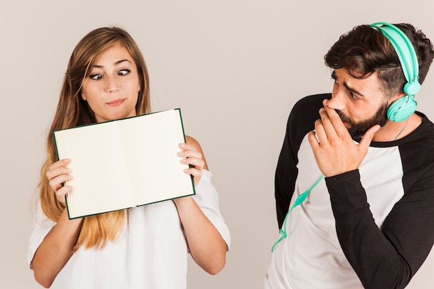 Funny couple showing open book