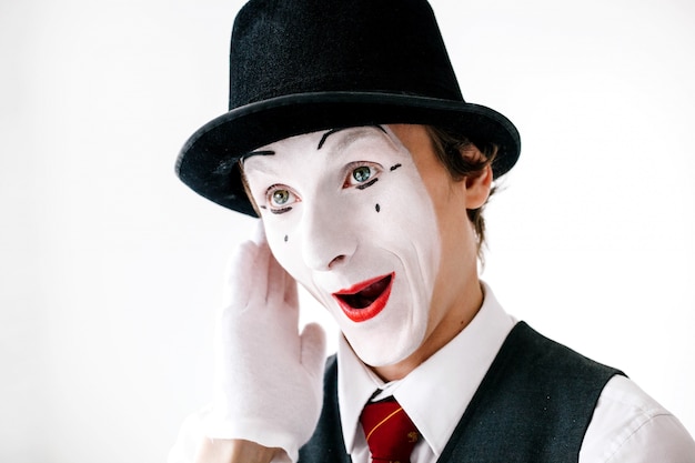 Free photo funny curious mime hears something