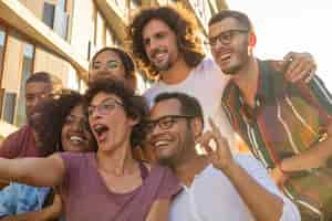 Free photo funny curly haired woman in glasses taking selfie