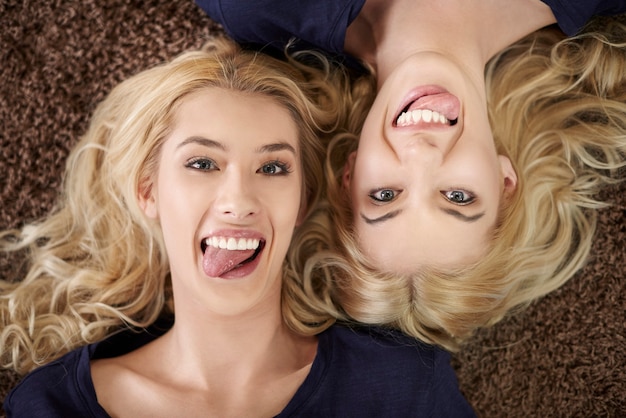 Funny faces of blonde twins