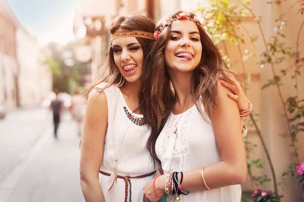 Funny faces of hippie female friends 
