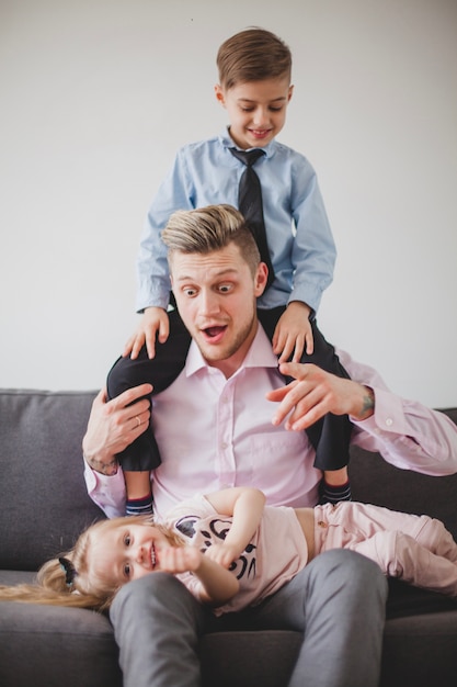 Free photo funny father with his son on his shoulders