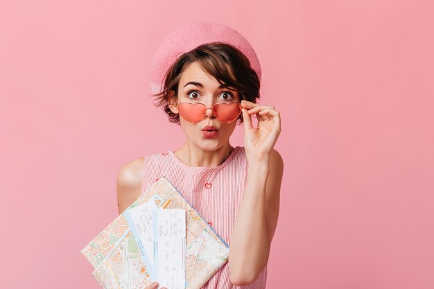 Funny french lady waiting for travel on pink wall