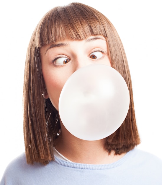 Free photo funny girl doing a bubble with chewing gum