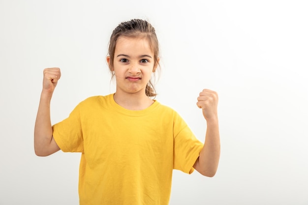 Free photo funny girl hand flexing demonstrating biceps isolated on white background