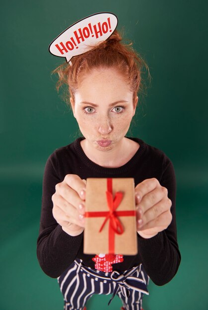 Funny girl showing a christmas present