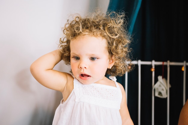 Funny girl standing on bed