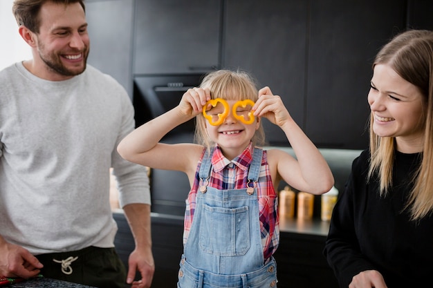 Free photo funny girl with pepper slices near parents