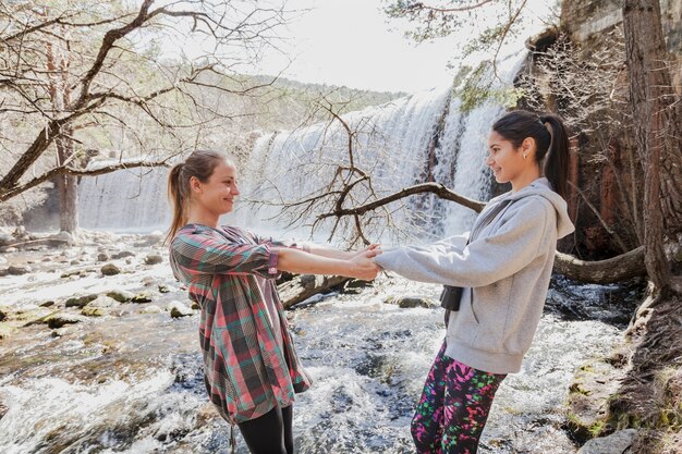 Funny girls playing by the river