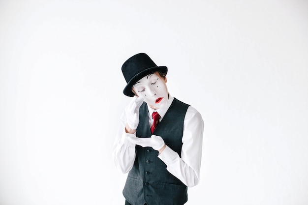 Free photo funny mime takes tears from his eyes