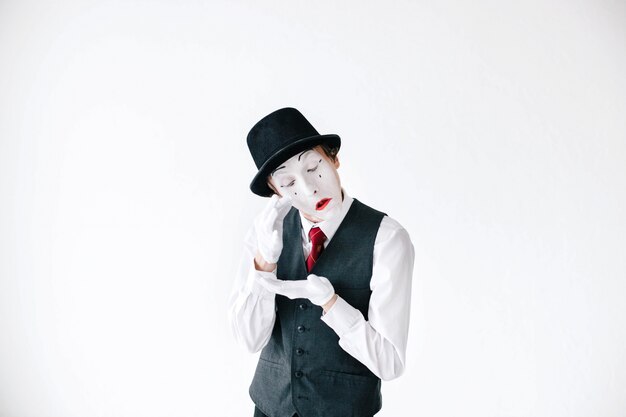 Funny mime takes tears from his eyes