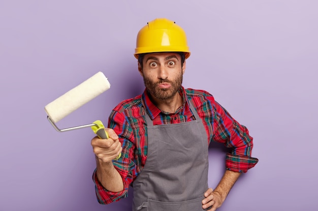 Free photo funny repairman wears hardhat, apron