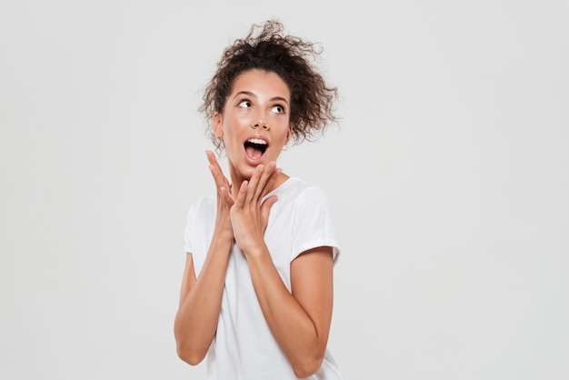 Free photo funny screaming curly woman looking away