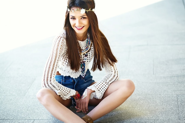 Free photo funny stylish sexy smiling beautiful young hippie woman model in summer white hipster clothes posing in the street