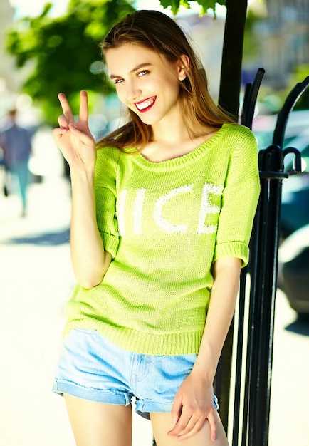 Funny  stylish sexy smiling beautiful young woman model in summer bright yellow   hipster cloth in the street