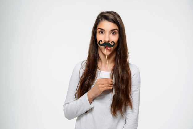 Funny teenage woman with fake moustache