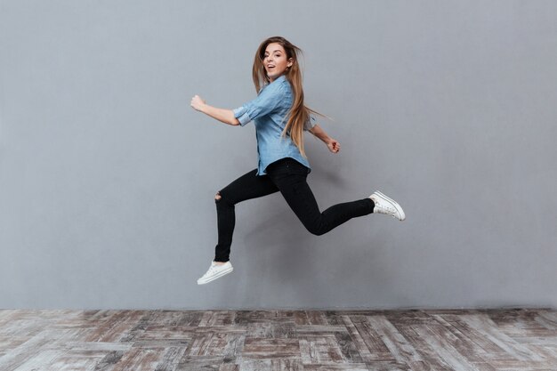 Funny Woman jumping in studio