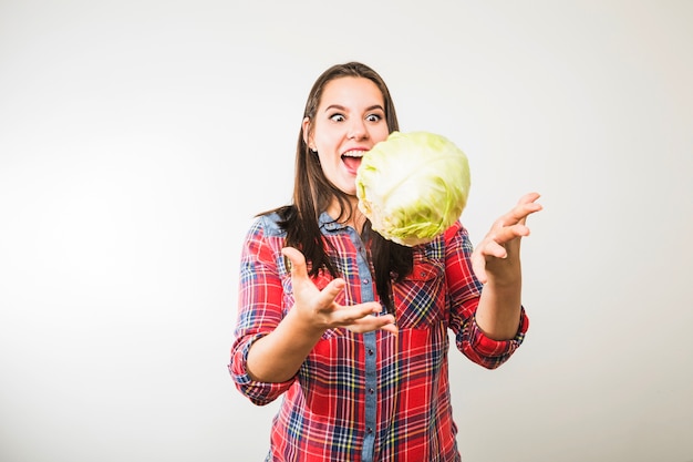 Funny woman throwing cabbage up