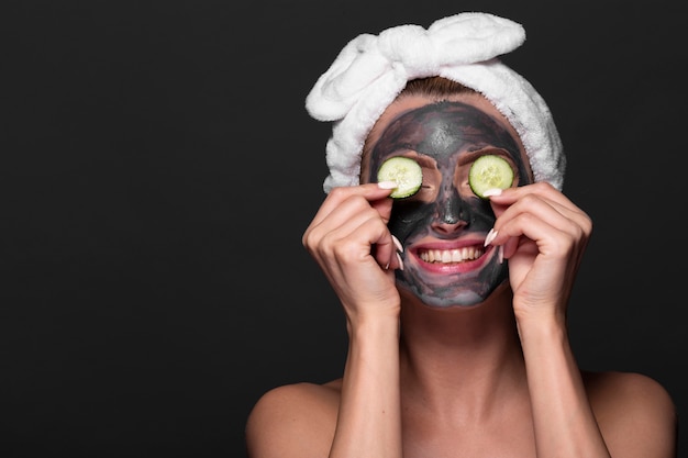 Funny woman with face mask treament