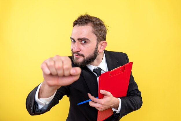 Funny young guy holding document and closing his fist