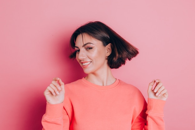 Funny young woman 20s in casual clothes isolated on pink background studio portrait. People emotions lifestyle concept. Shaking head with flowing hair