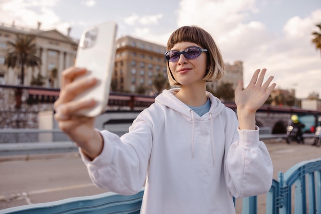 Funny young woman waving hand